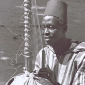 Alhaji Bai Konte seated with a kora